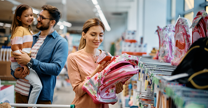 family preparing for back to school looking at backpack