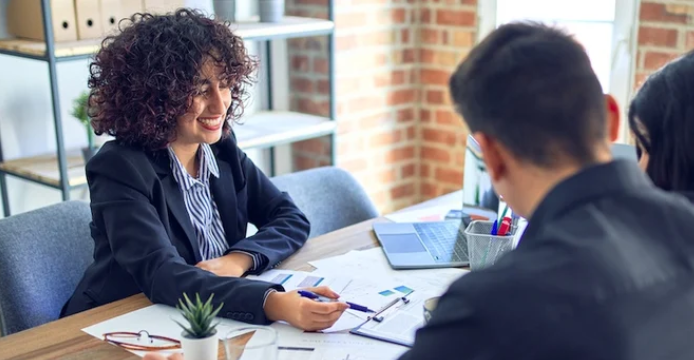business banker going over small business paperwork with customers