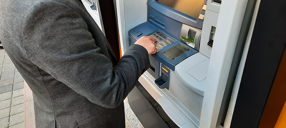 young businessman withdrawing funds from atm