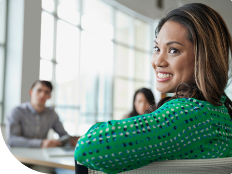 woman at table smiling looking into the distance