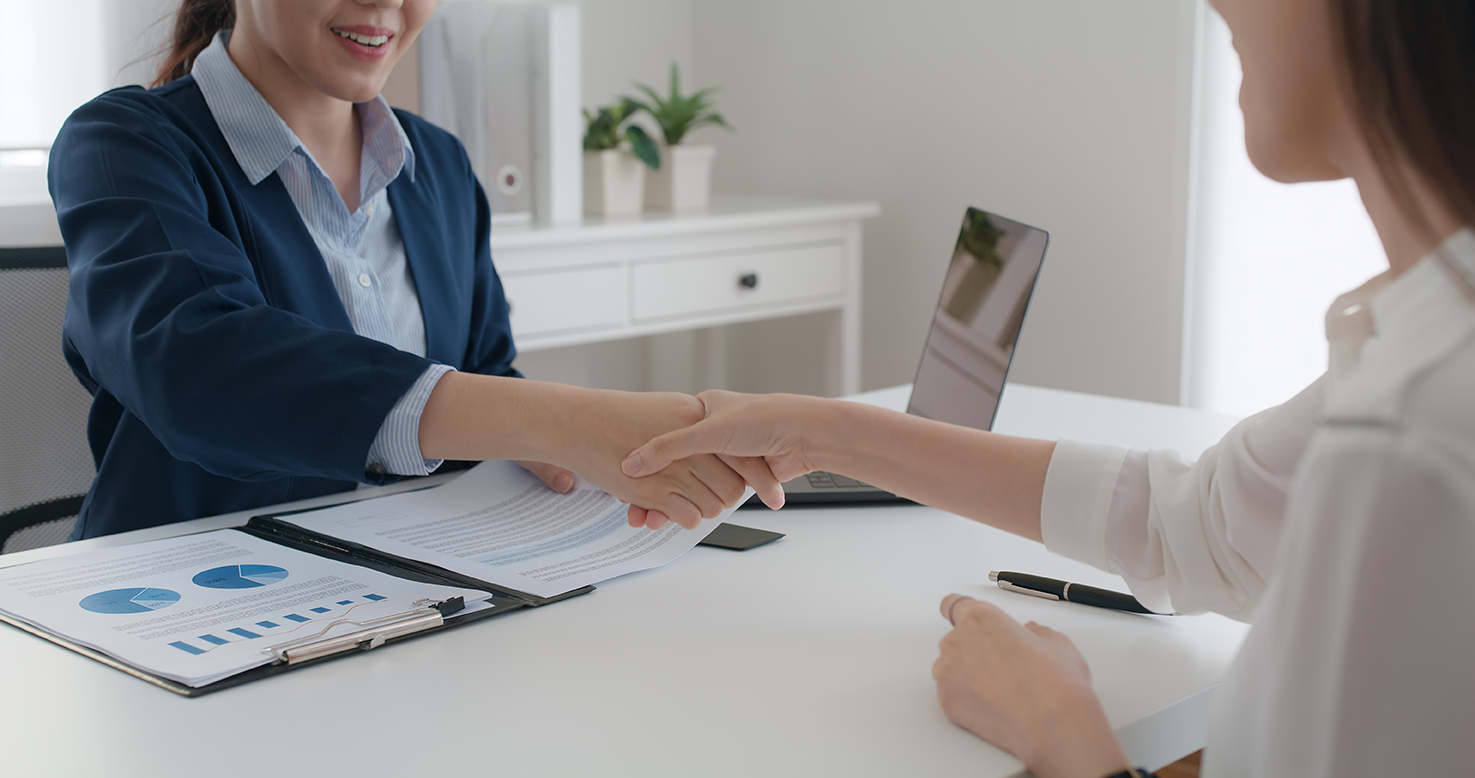 woman shaking hands with investment broker