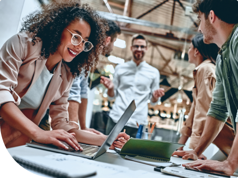 people smiling over a work table