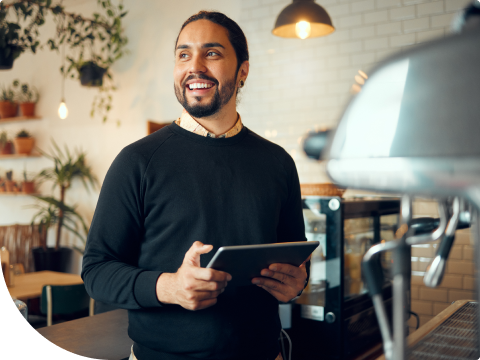 Businessman smiling while looking at business banking on tablet