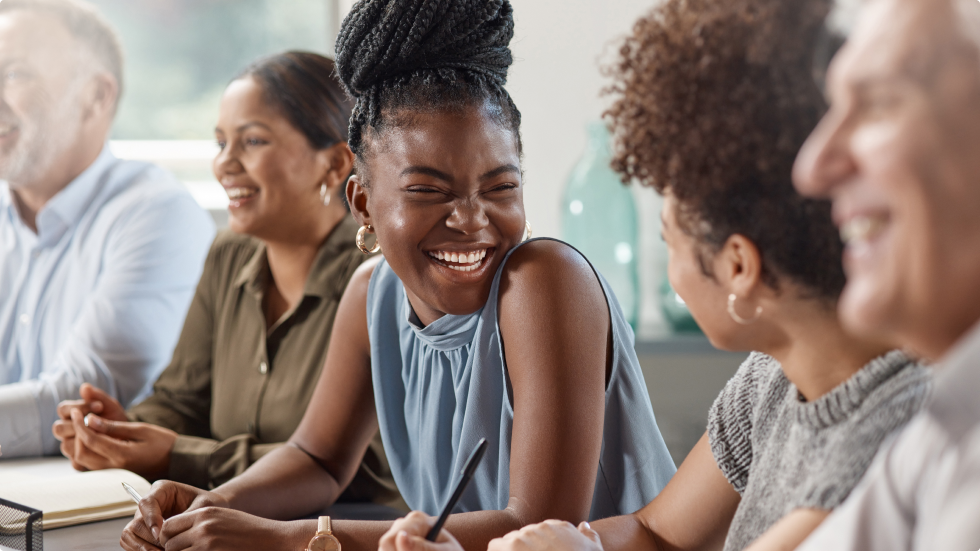 group of people smiling at a table