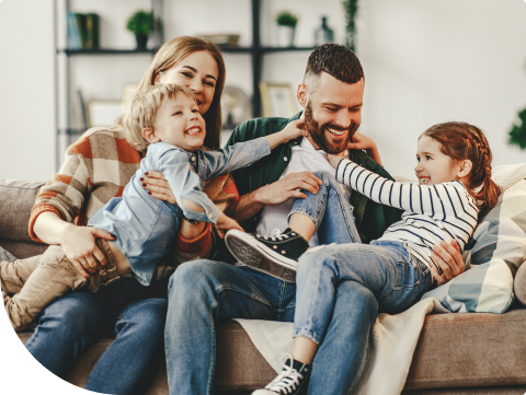 family of four playing around on their couch
