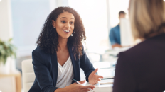 female banker sitting at a desk talking to a client