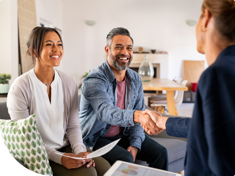 couple shaking hands with banker