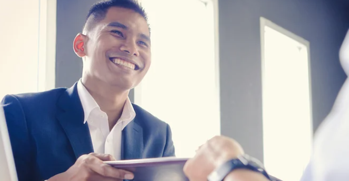 Small Business Owner being handed documents from banker