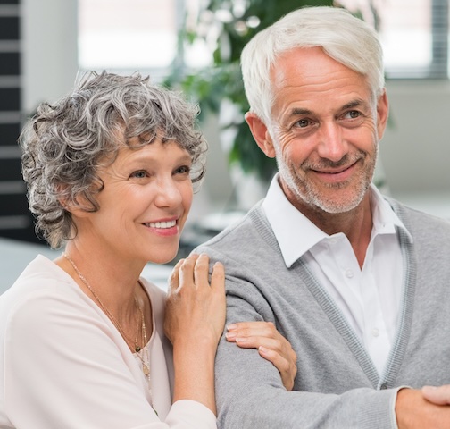 Older couple smiling after retirement