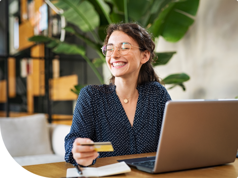 woman smiling while making purchase with debit card