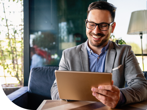 man looking at smart tablet smiling