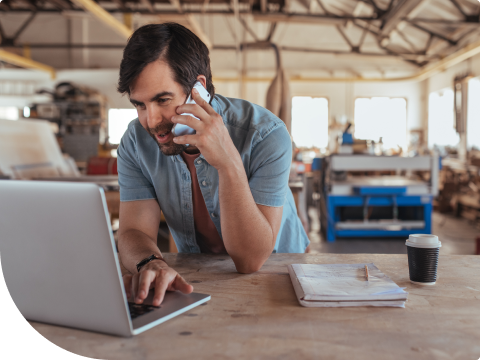 Businessman checking online banking platform while talking on smartphone
