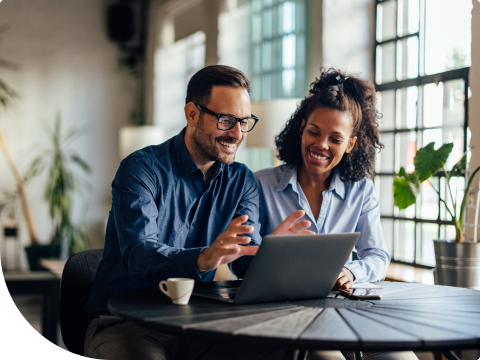 young couple looking at laptop screen going over finances