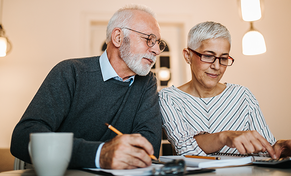 older couple looking up financials and planning
