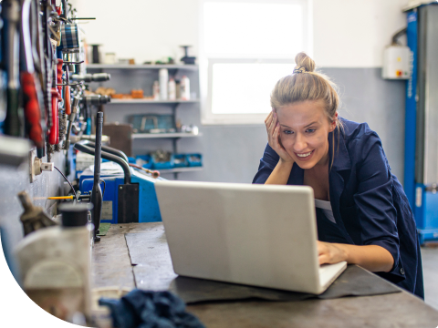 Businesswoman checking online banking platform while working in factory