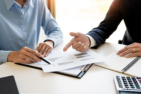close up of a persona and investment broker going over portfolio