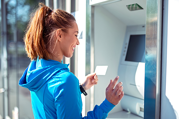 Woman using ATM
