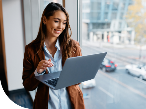young businesswoman enjoying her investment portfolio on laptop